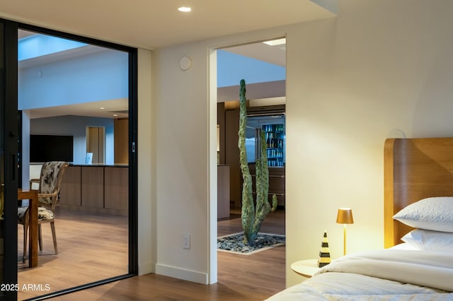 bedroom with baseboards, recessed lighting, and wood finished floors