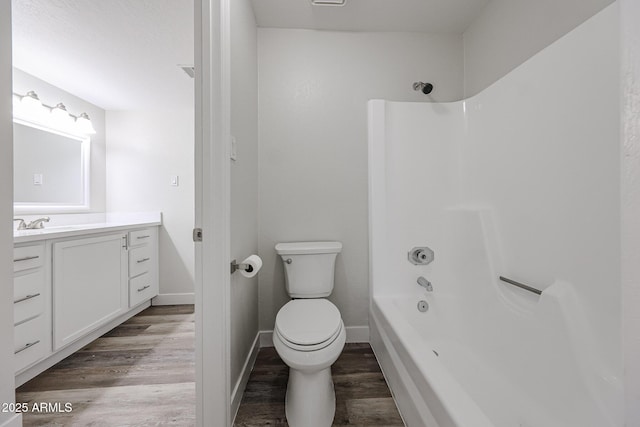 full bathroom with toilet, shower / bath combination, wood finished floors, and vanity