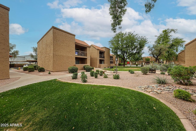 view of property's community with a lawn
