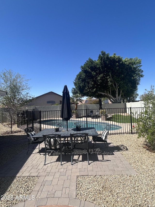 view of patio / terrace featuring a fenced in pool and fence