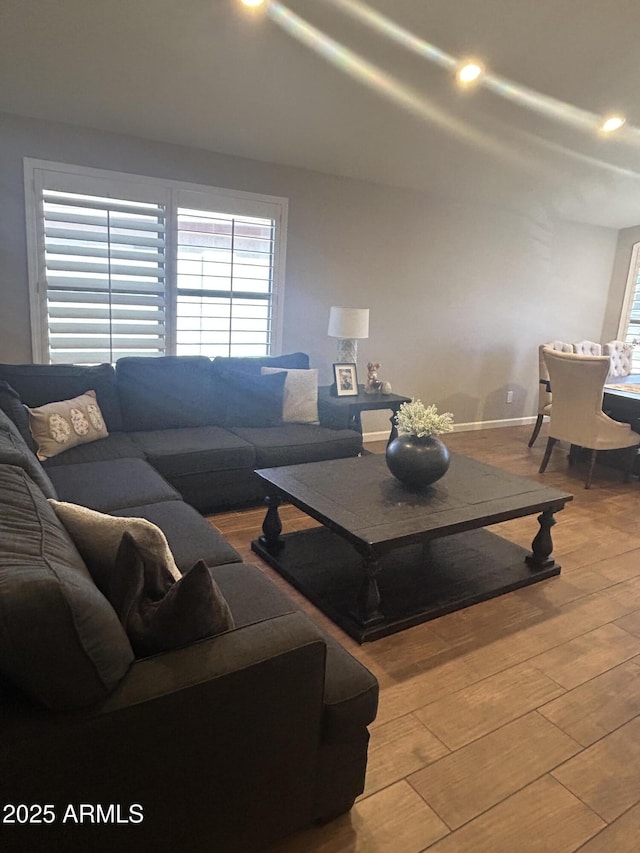 living area featuring recessed lighting, baseboards, and wood finished floors