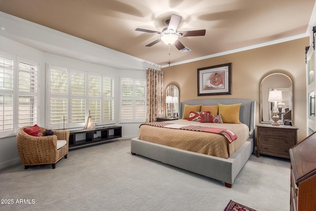 carpeted bedroom featuring multiple windows, ceiling fan, and crown molding