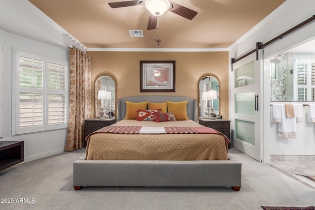 carpeted bedroom with ceiling fan, a barn door, ornamental molding, and multiple windows