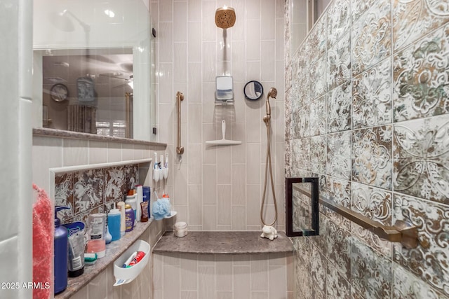 bathroom featuring a tile shower and tile walls