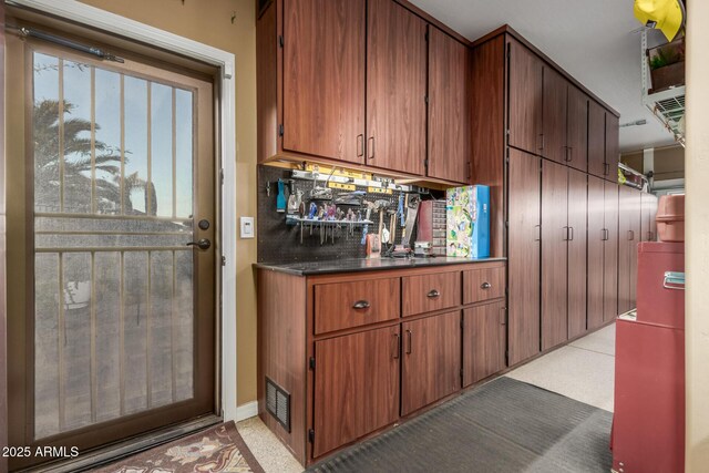 kitchen with light tile patterned floors and backsplash