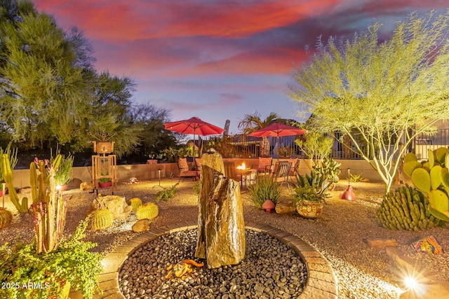 yard at dusk with a patio area