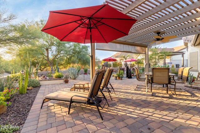 view of patio / terrace with ceiling fan and a pergola