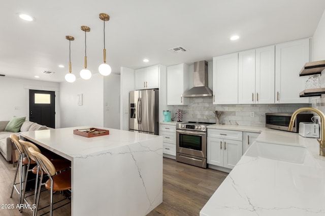 8547 E Roanoke Ave, Scottsdale, AZ 85257 - kitchen with wall chimney range hood, open shelves, open floor plan, appliances with stainless steel finishes, and visible vents
