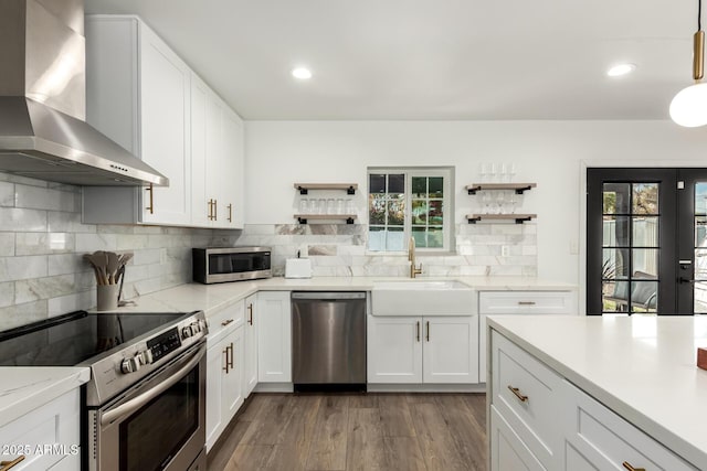 8547 E Roanoke Ave, Scottsdale, AZ 85257 - kitchen with open shelves, plenty of natural light, appliances with stainless steel finishes, and wall chimney range hood