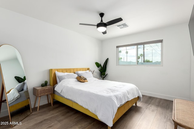 8547 E Roanoke Ave, Scottsdale, AZ 85257 - bedroom featuring baseboards, wood finished floors, visible vents, and a ceiling fan