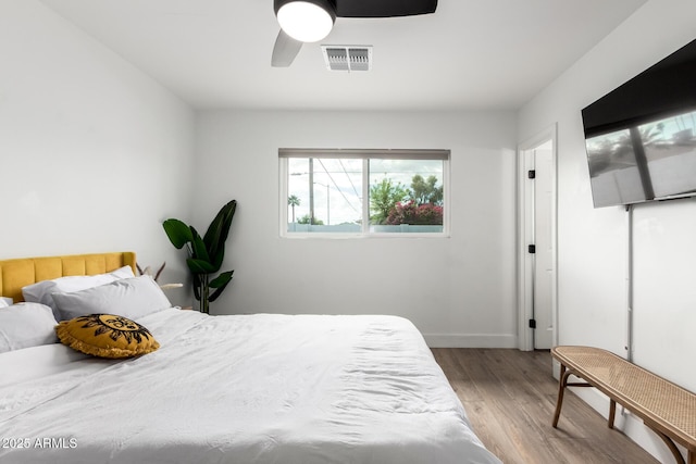 8547 E Roanoke Ave, Scottsdale, AZ 85257 - bedroom with baseboards, a ceiling fan, wood finished floors, and visible vents