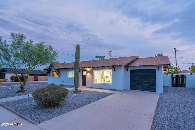 8547 E Roanoke Ave, Scottsdale, AZ 85257 - ranch-style house with concrete driveway, a shingled roof, fence, a garage, and stucco siding