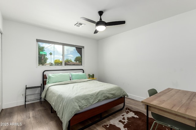 8547 E Roanoke Ave, Scottsdale, AZ 85257 - bedroom featuring baseboards, a ceiling fan, wood finished floors, and visible vents