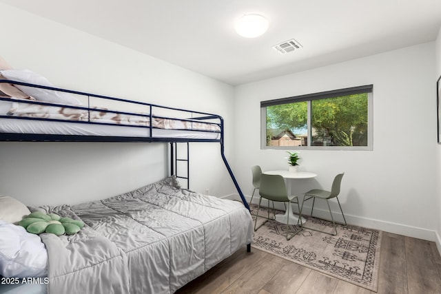 8547 E Roanoke Ave, Scottsdale, AZ 85257 - bedroom featuring baseboards, wood finished floors, and visible vents