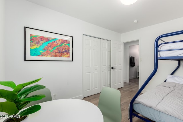 8547 E Roanoke Ave, Scottsdale, AZ 85257 - bedroom with light wood-style flooring, a closet, and baseboards