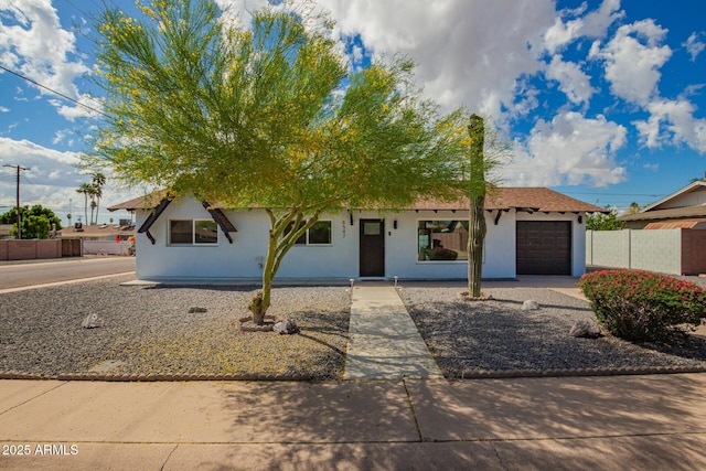 8547 E Roanoke Ave, Scottsdale, AZ 85257 - view of front of home with fence, concrete driveway, stucco siding, and a garage