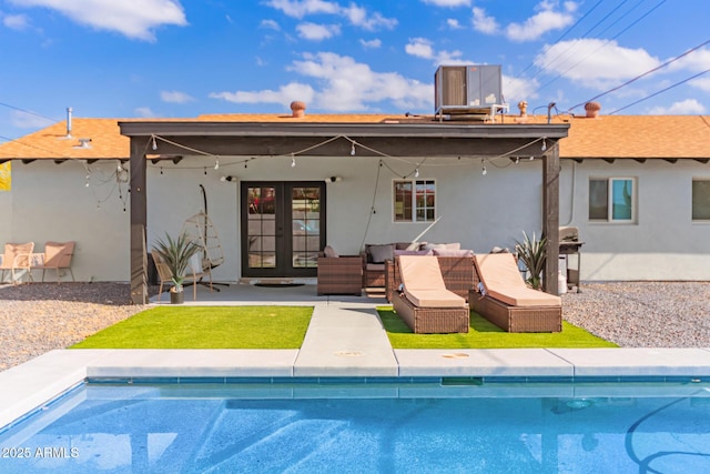 8547 E Roanoke Ave, Scottsdale, AZ 85257 - rear view of property with french doors, central AC, an outdoor pool, and stucco siding