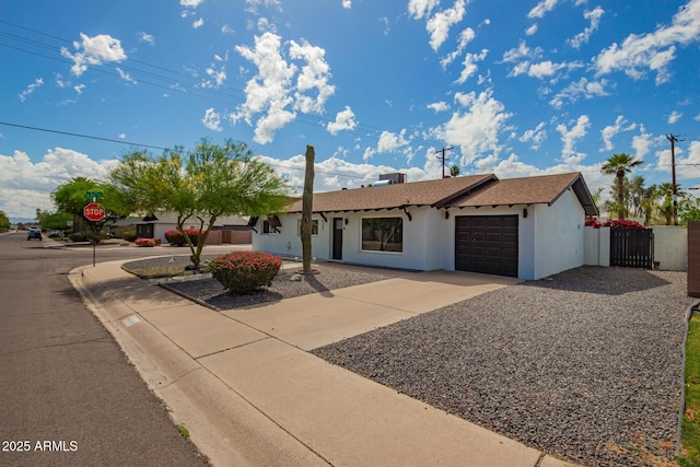 8547 E Roanoke Ave, Scottsdale, AZ 85257 - ranch-style home with a gate, driveway, fence, a garage, and stucco siding