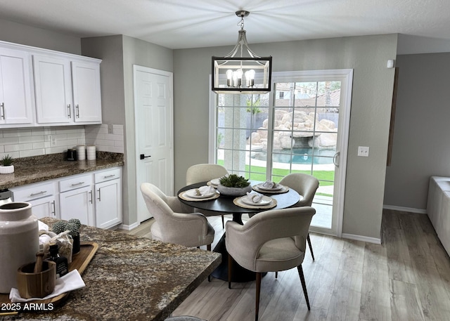 dining space featuring a notable chandelier and light hardwood / wood-style floors