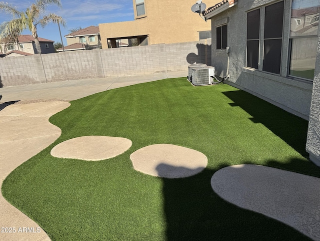 view of yard with a patio and central air condition unit