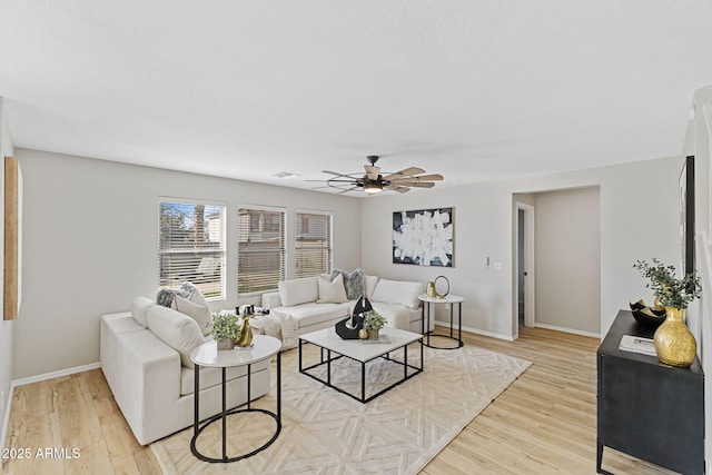 living room featuring light hardwood / wood-style floors and ceiling fan