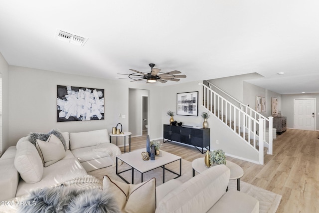 living room featuring light hardwood / wood-style flooring and ceiling fan