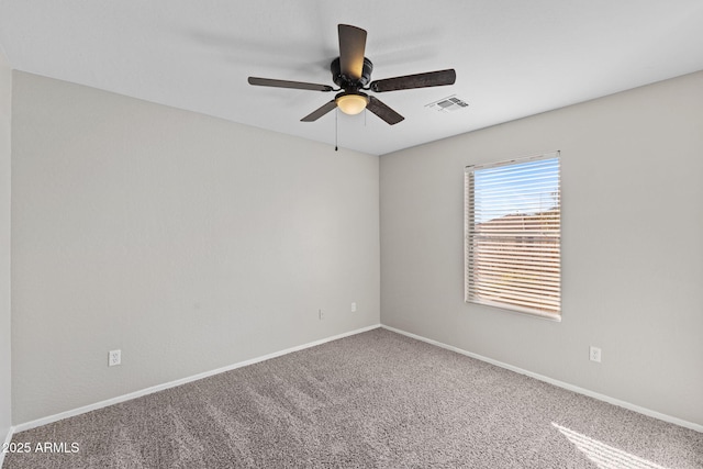 carpeted empty room featuring ceiling fan