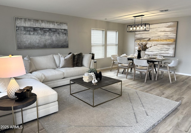 living room featuring hardwood / wood-style floors and a chandelier