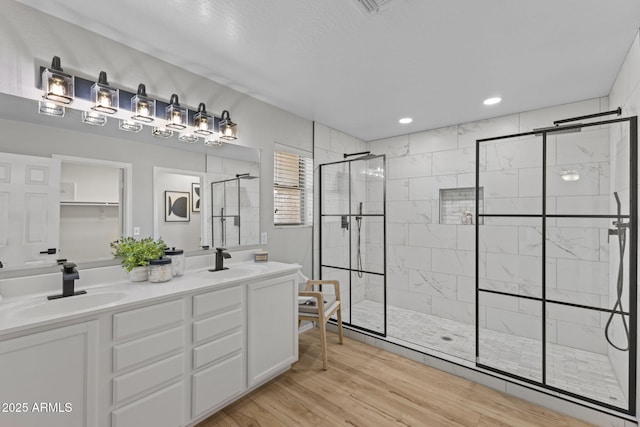 bathroom featuring an enclosed shower, vanity, and hardwood / wood-style flooring