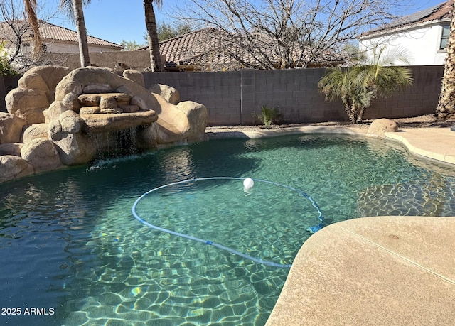 view of swimming pool with pool water feature