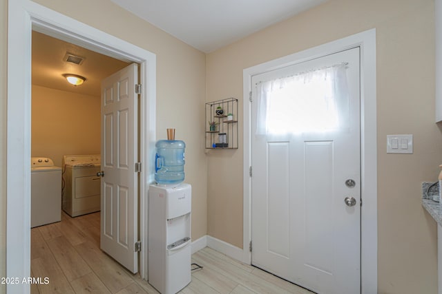 entrance foyer featuring light hardwood / wood-style flooring and independent washer and dryer