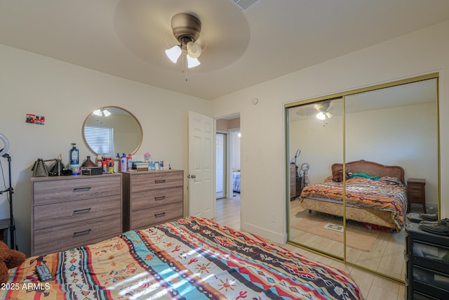 bedroom featuring ceiling fan and a closet