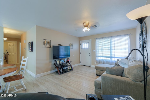 living room with ceiling fan and light hardwood / wood-style flooring