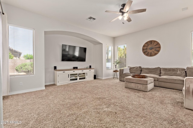 living room featuring carpet floors, ceiling fan, and baseboards