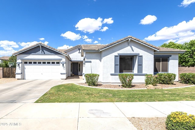 ranch-style home featuring a garage, concrete driveway, a tile roof, and stucco siding