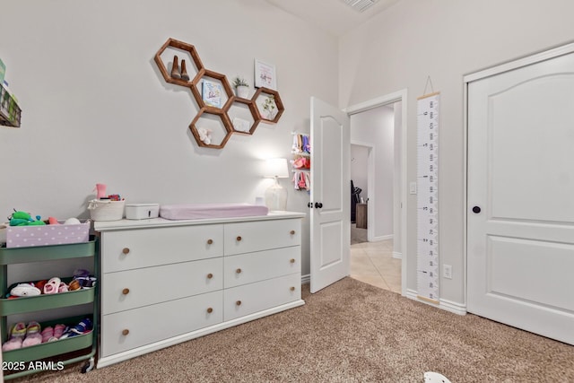 bedroom featuring light colored carpet