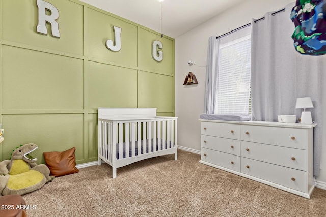 bedroom with carpet flooring, baseboards, and a nursery area