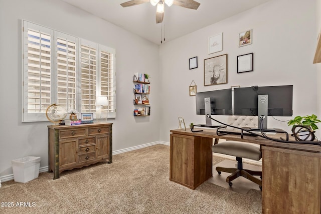 office area with a ceiling fan, light colored carpet, and baseboards