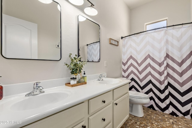full bath featuring toilet and double vanity