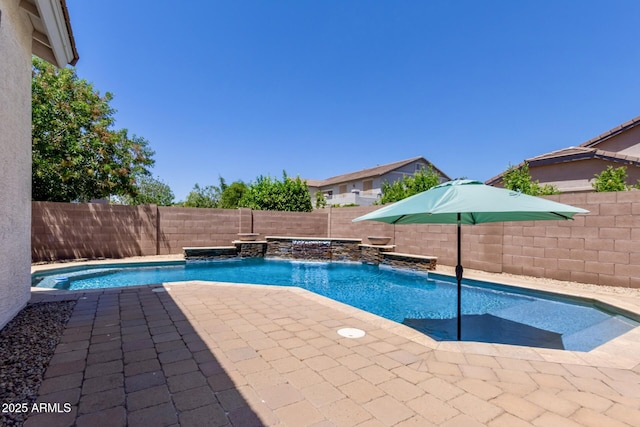 view of pool with a fenced backyard and a patio area