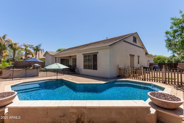 view of pool with a patio area and fence