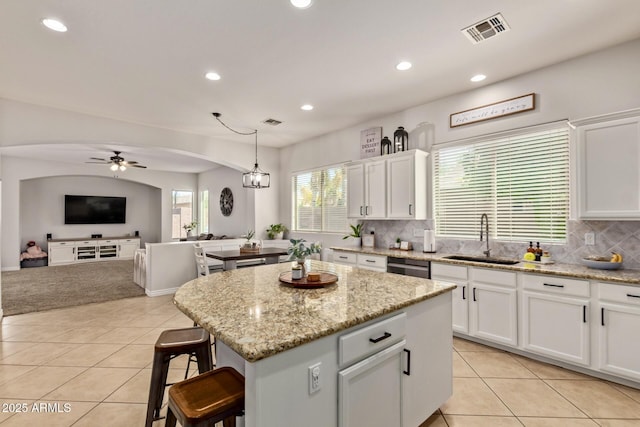 kitchen with a sink, ceiling fan, light tile patterned floors, white cabinets, and recessed lighting