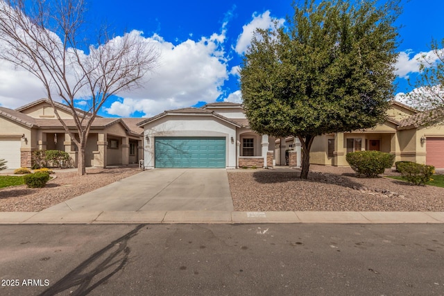 view of front of house with stucco siding, driveway, an attached garage, and a tile roof