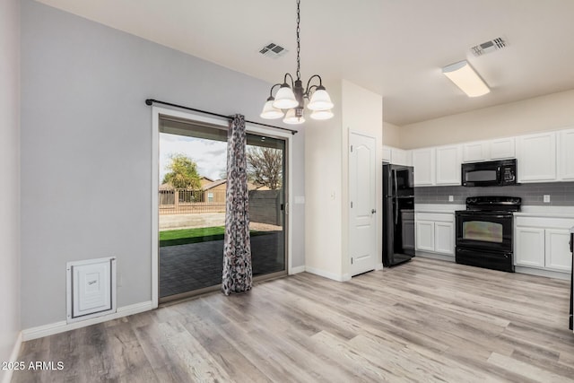 kitchen with visible vents, tasteful backsplash, black appliances, and white cabinetry