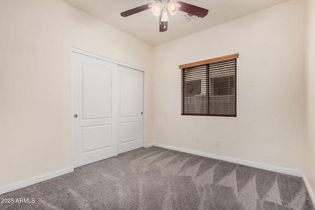 unfurnished bedroom with visible vents, baseboards, ceiling fan, a closet, and carpet flooring