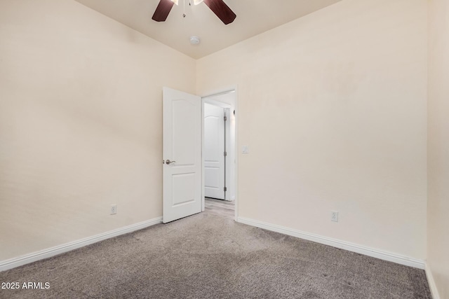 unfurnished room with vaulted ceiling, a ceiling fan, baseboards, and carpet floors