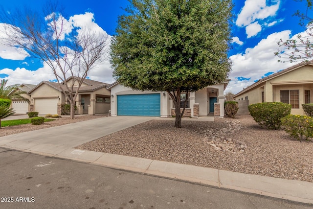 view of front of property featuring stucco siding, an attached garage, and driveway