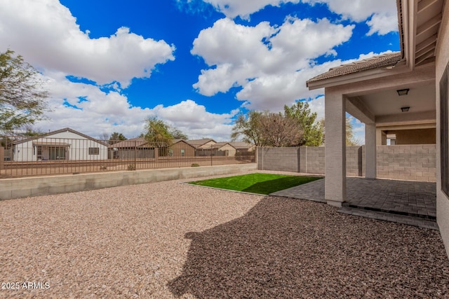 view of yard featuring a patio area, a residential view, and a fenced backyard