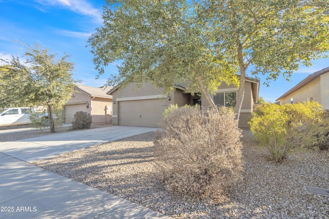 view of property hidden behind natural elements with a garage