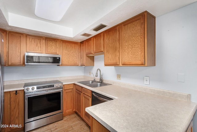2154 E Forge Ave, Mesa, AZ 85204 - kitchen featuring appliances with stainless steel finishes, a sink, light wood-style floors, and light countertops